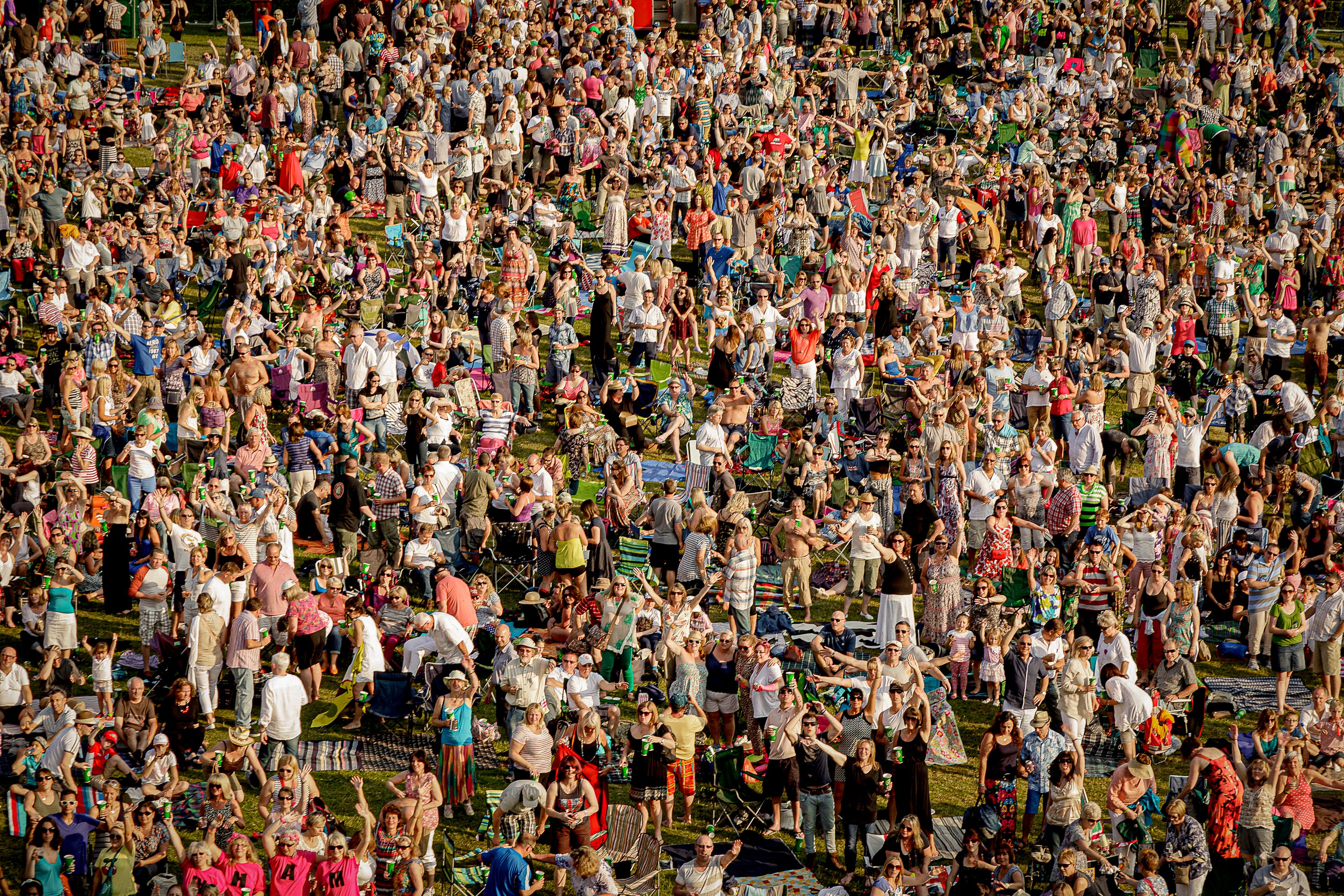Overhead photography of large music festival audience in the sunshine
