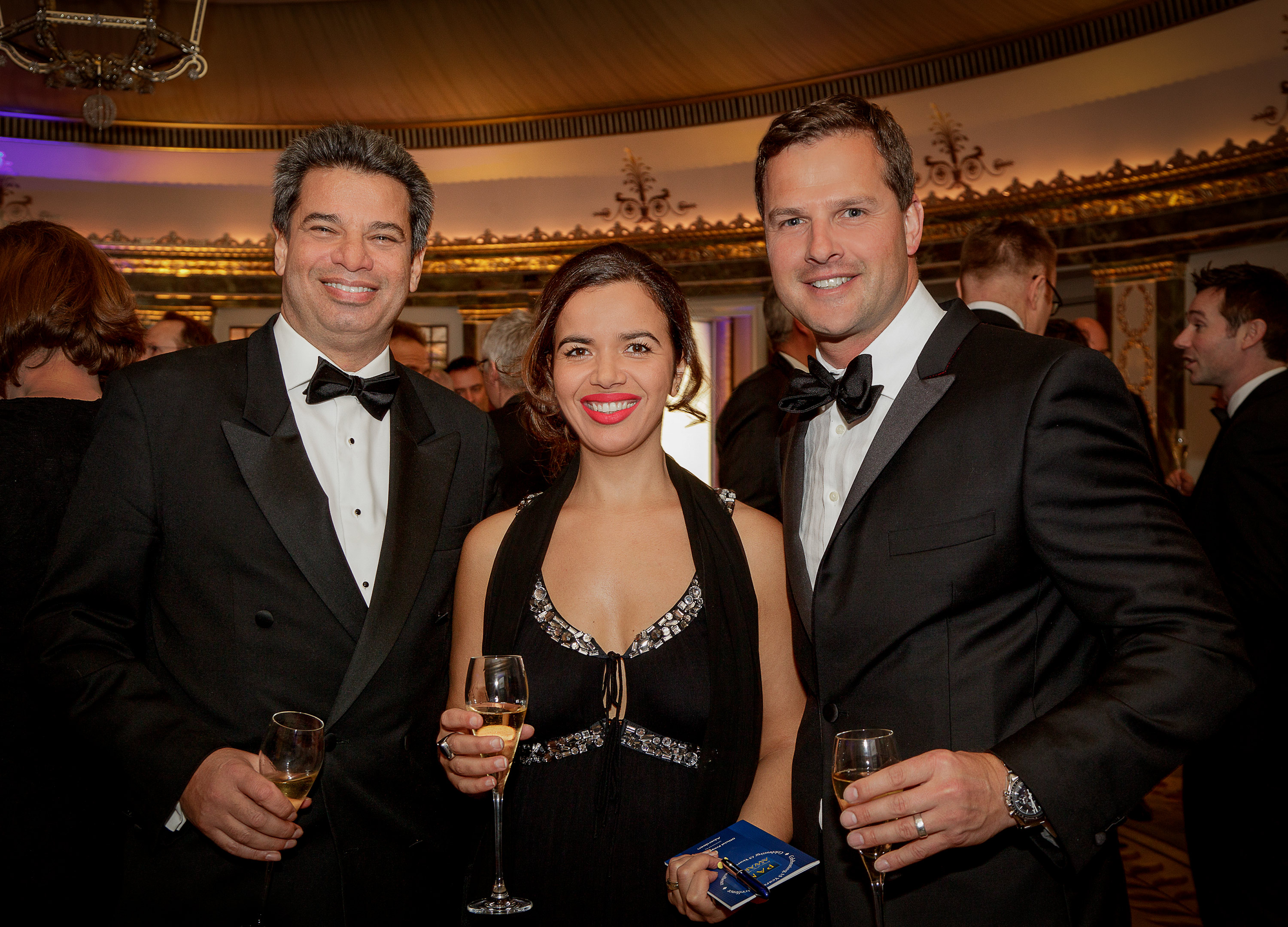 Group photo of attendees wearing black tie at a corporate awards ceremony