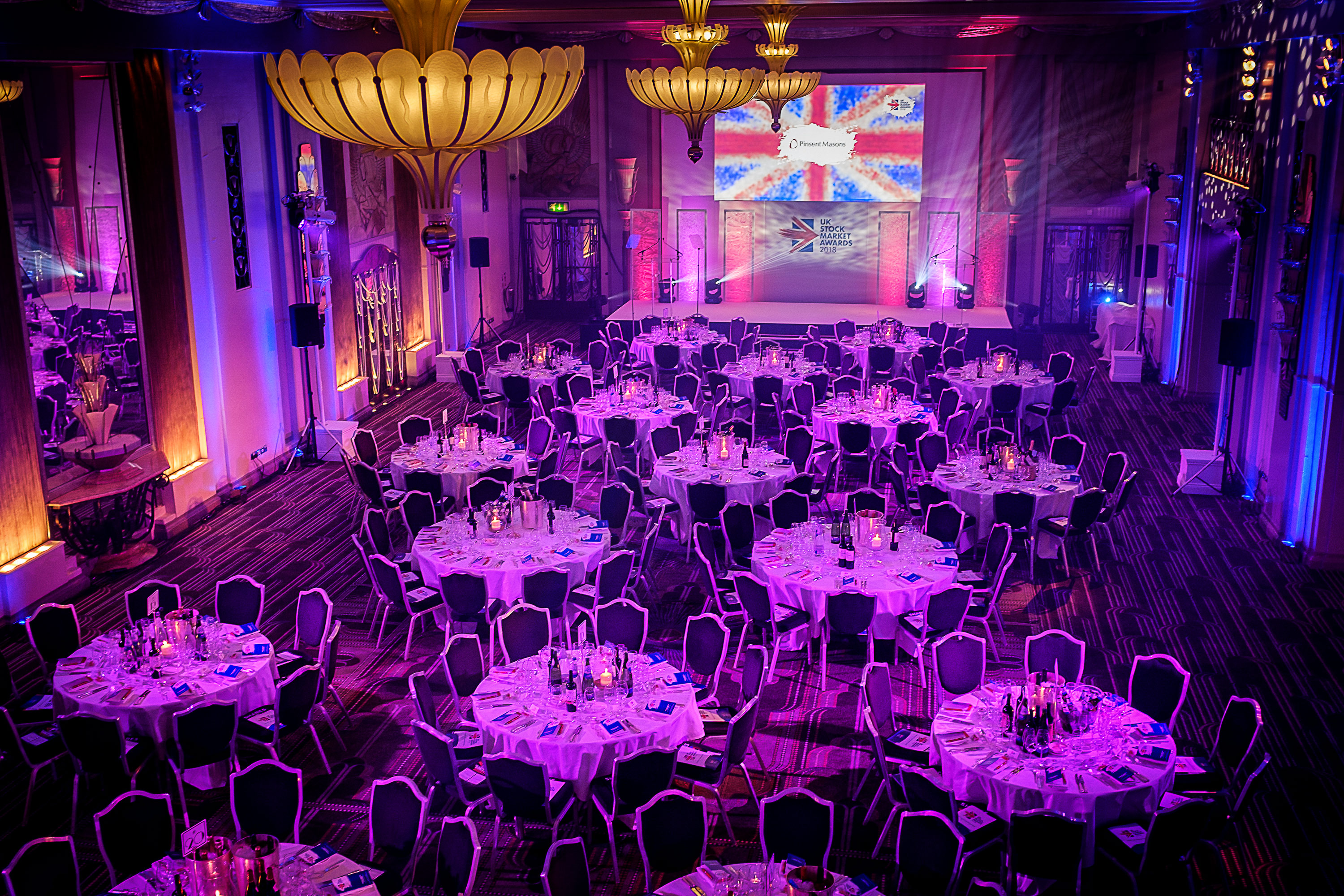 Company dinner event setup with ambient pink lighting