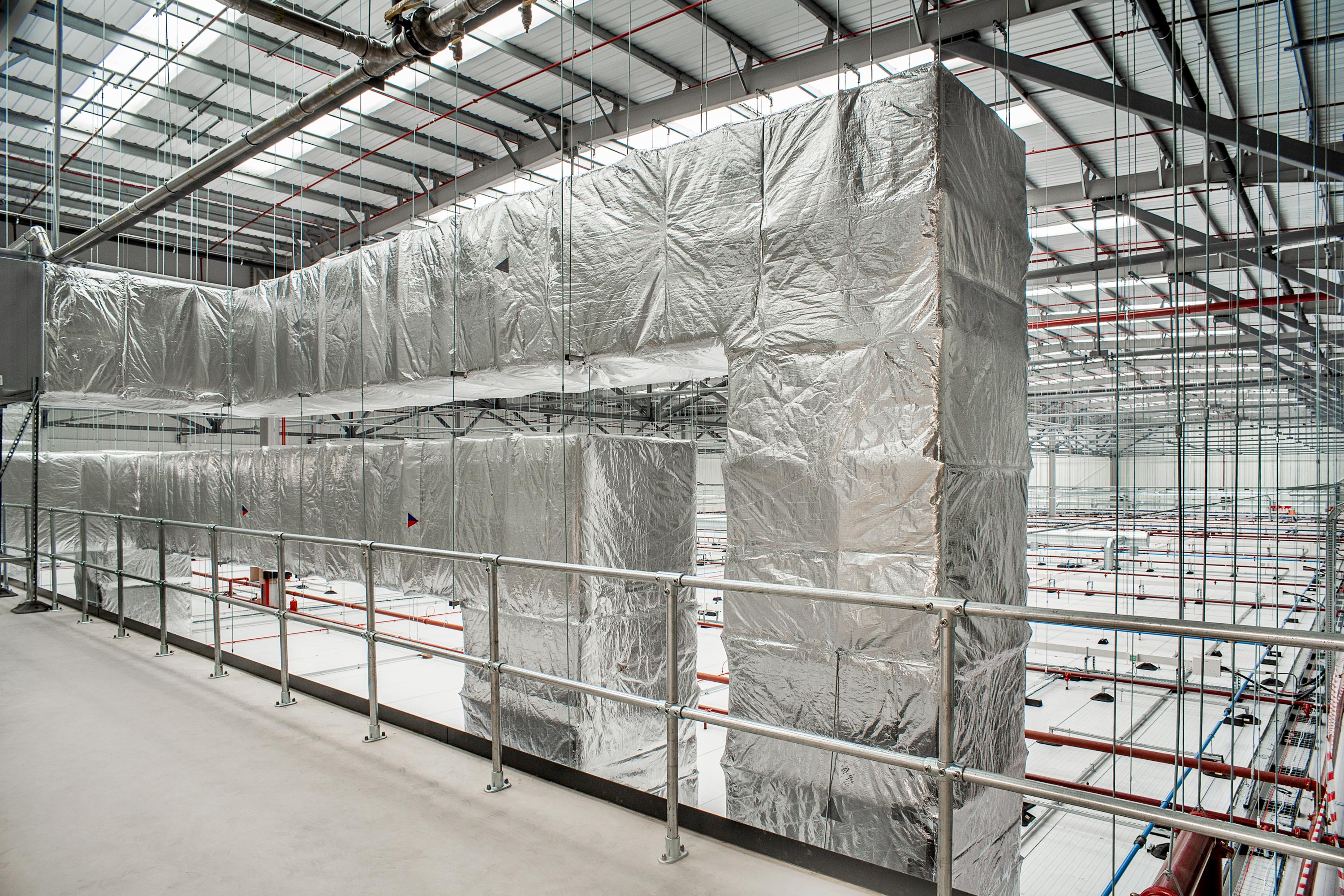 A scene inside an industrial unit of silver duct cladding insulation