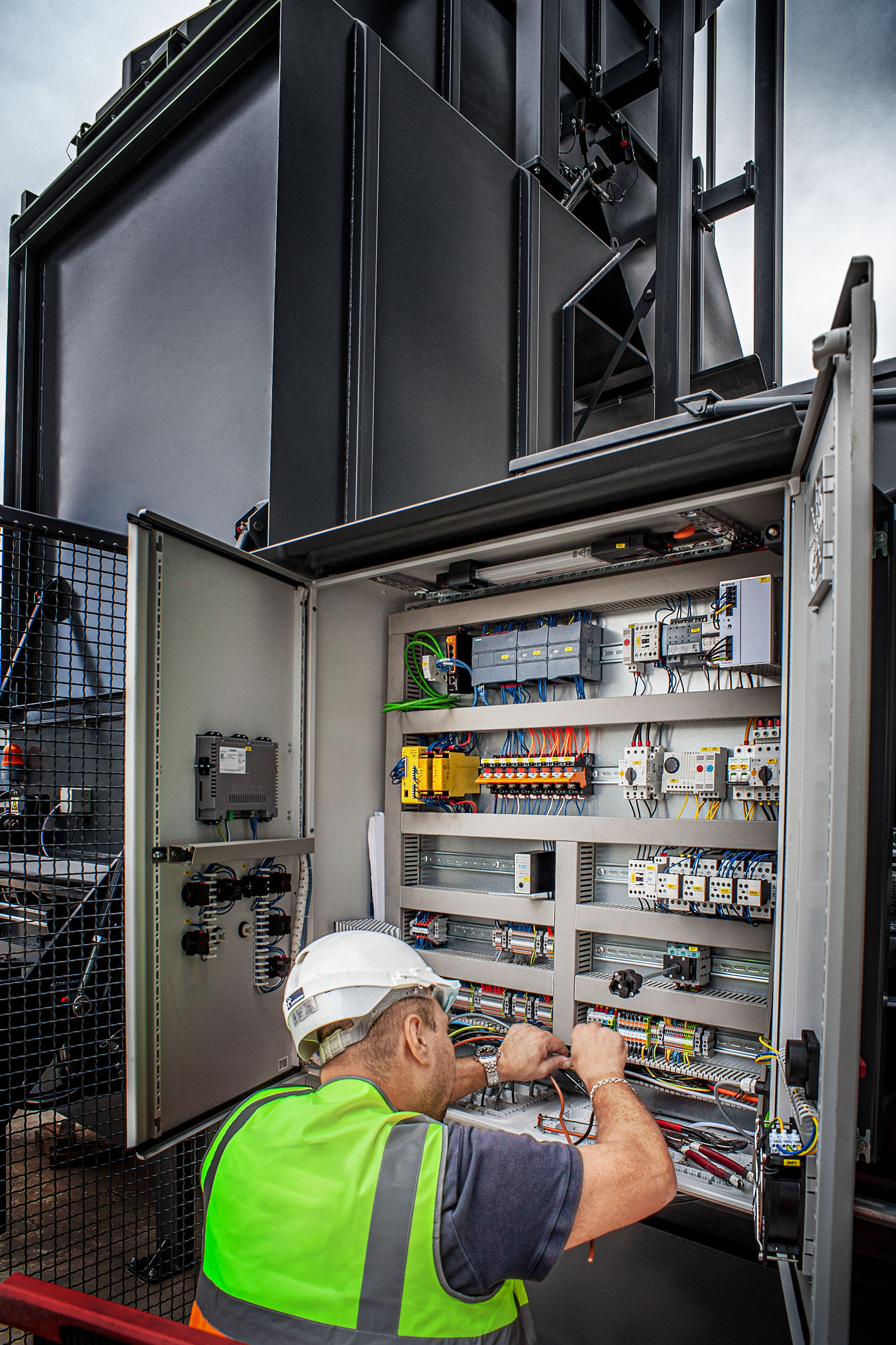 Commercial photography of man fitting electric box