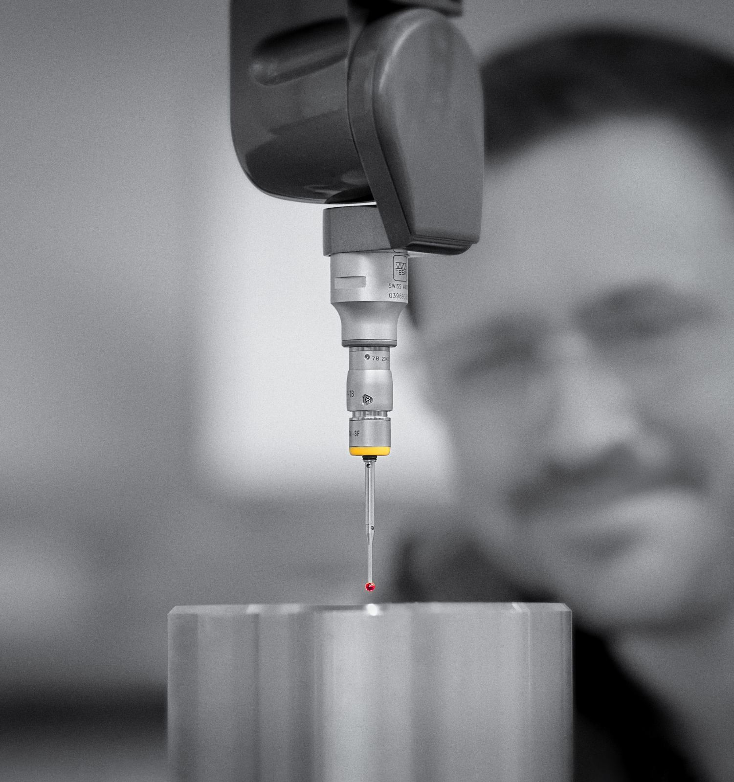 Close up of industrial measuring process with man’s face in background