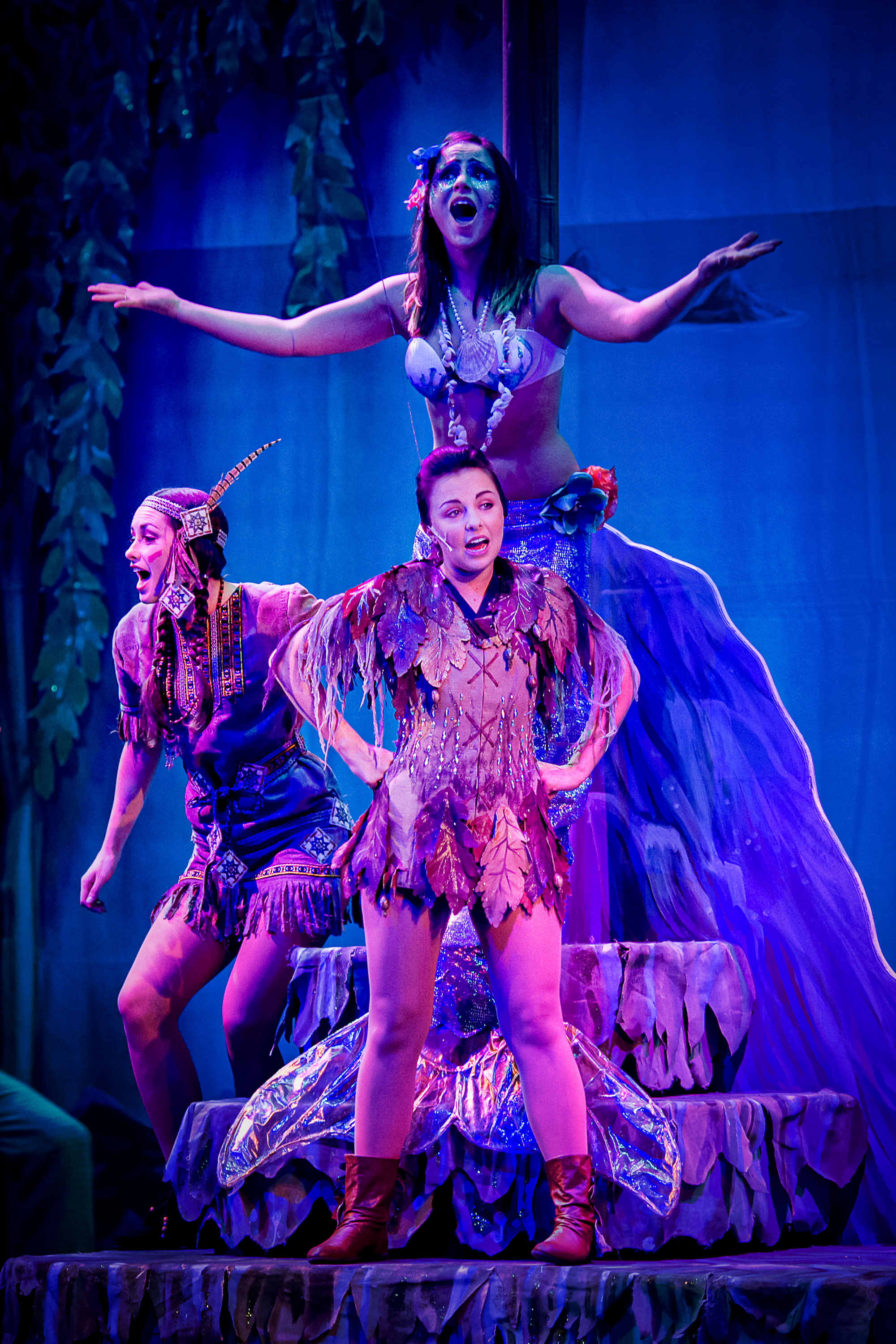 Three women in costume in a theatre performance