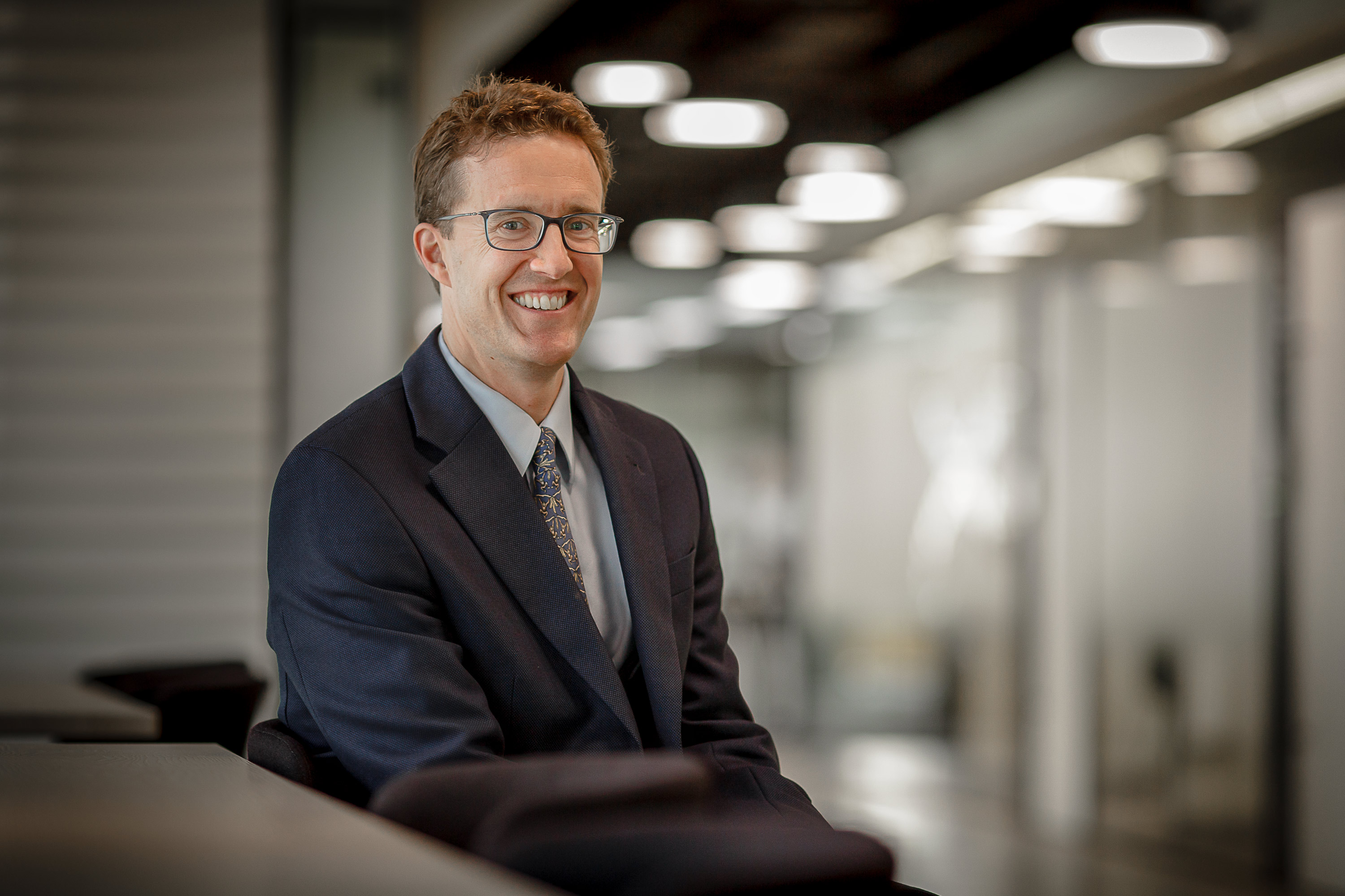 Corporate meet the team portrait of a smiling man in an office
