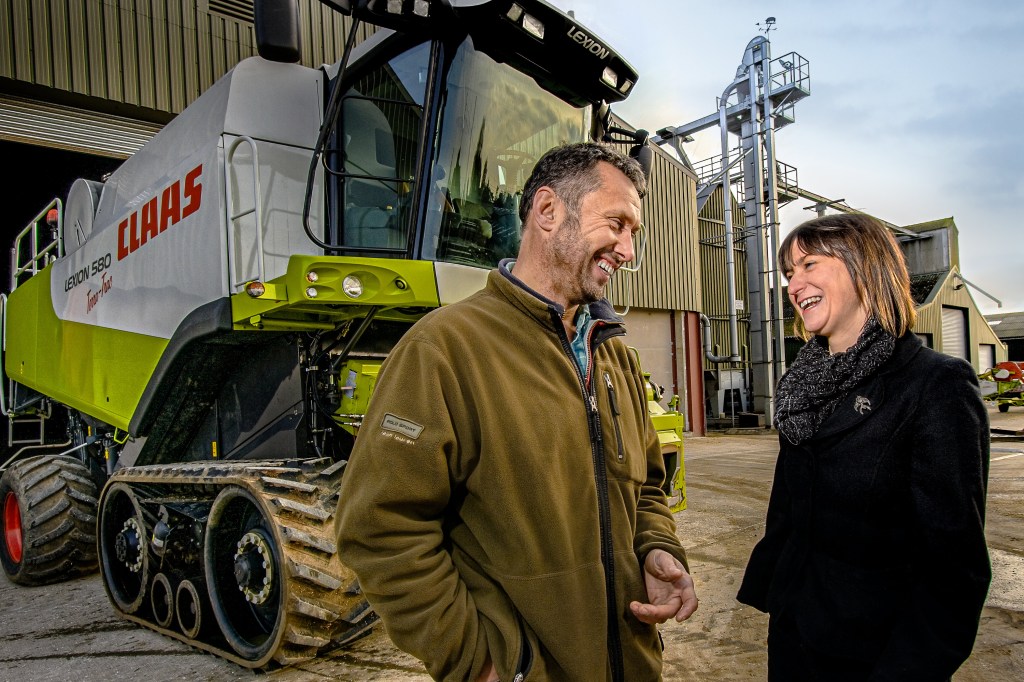 Employees chatting and smiling at a Claas agricultural machinery site