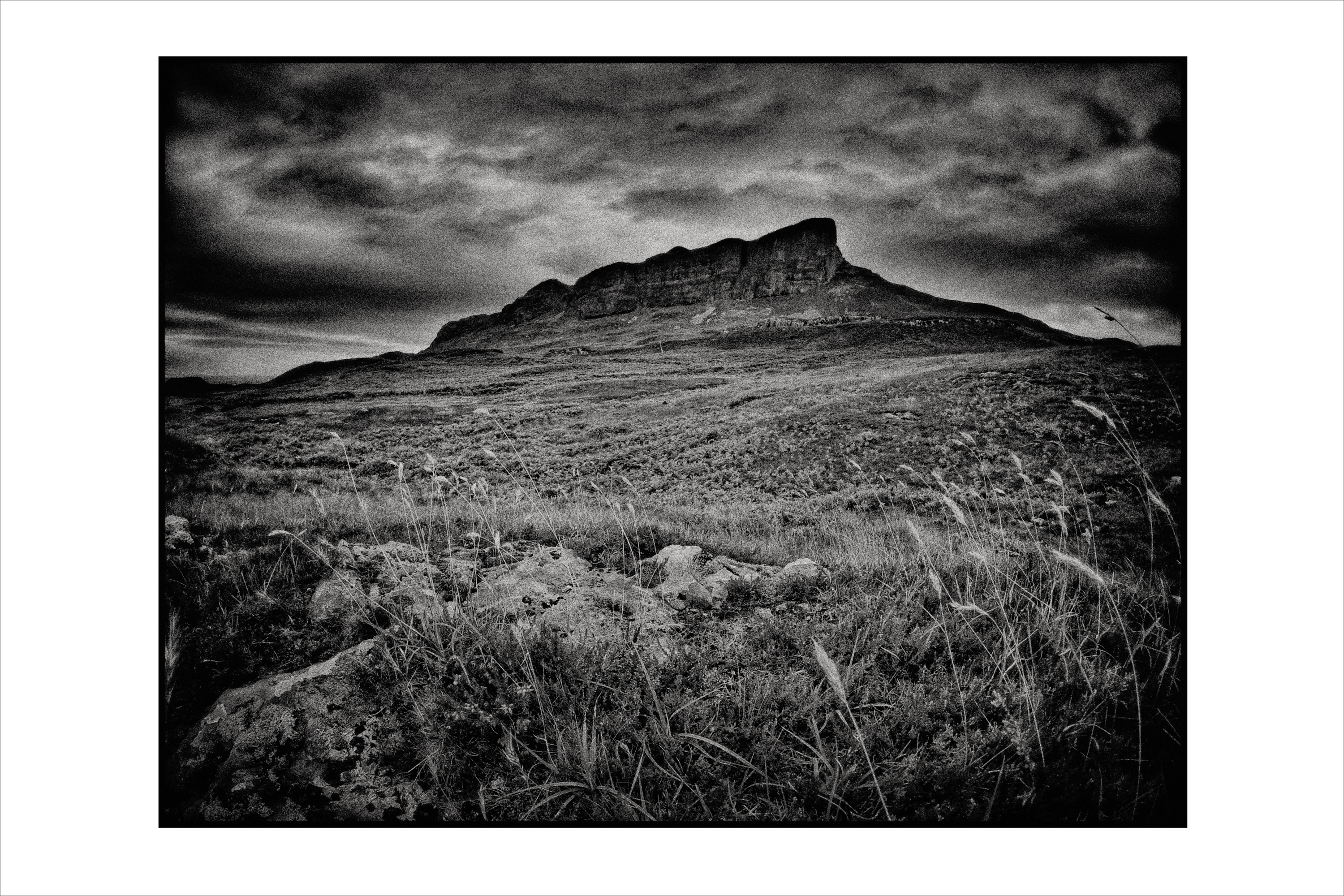 Black and White landscape of An Sgùrr with moody sky taken of An Sgùrr Scotland. Photographed on film